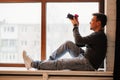 photographer sits on windowsills and takes pictures. training in photography.