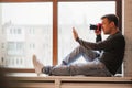 photographer sits on windowsills and takes pictures. training in photography.