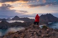 A photographer standing on top of Padar island and talking picture of beautiful landscape at sunset, Flores island in Komodo