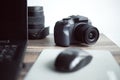 Photographer or stock photography concept, digital black camera near laptop on desk workstation Royalty Free Stock Photo