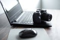 Photographer or stock photography concept, digital black camera near laptop on desk workstation