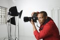 Photographer in studio. Royalty Free Stock Photo