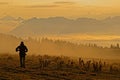 Photographer in the sunrise lights of Semnoz