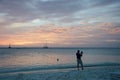 Photographer at the Sunset with anchored sail boats