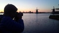 Photographer take a photo of windmills