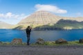Photographer takes a photo of kaldbaksfjordur fiord from a butte