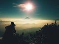 Photographer takes photos with camera on snowy peak