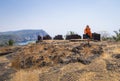 The photographer takes a picture of the remains of the fortress of Cabo de Rama in India on a blue background of sky, sea and