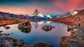 Photographer takes picture of Stellisee lake with Matterhorn peak on background.