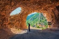 Photographer takes picture in tunel to Piva river pass.