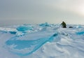 Photographer takes pictures frozen clear ice in winter lake baikal, russia