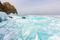 Photographer takes pictures frozen clear ice in winter lake baikal, russia