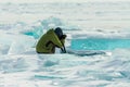 Photographer takes pictures frozen clear ice in winter lake baikal, russia