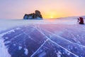 Photographer takes pictures winter ogoy island at sunrise in the ice of Lake Baikal, Russia