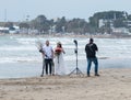 Photographer takes pictures of a young couple with a horse on the Mediterranean coast near the city Ako in Israel