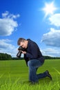 Photographer taking macro picture of green grass