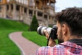 Photographer taking photo of beautiful house with professional camera Royalty Free Stock Photo