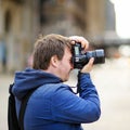 Photographer taking photo with professional digital camera Royalty Free Stock Photo