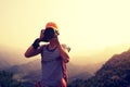 Photographer taking photo on top of mountain Royalty Free Stock Photo