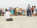 Photographer taking photos of group on beach