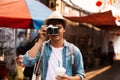 Photographer taking photos of lively streets with restaurants Royalty Free Stock Photo