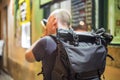 Photographer taking photos of lively streets with restaurants Royalty Free Stock Photo