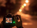 Photographer taking photos with tripot at night. street photography with tripod on the street Royalty Free Stock Photo