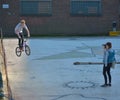 Photographer taking a picture of a boy jumping with his bike