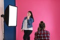 Photographer taking picture of woman in studio. Plus size model Royalty Free Stock Photo