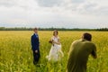 Photographer taking pictures couple of newlyweds Royalty Free Stock Photo