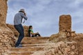 Photographer taking pictures girl, location Kasbah Ait Ben Haddou near Ouarzazate in the Atlas Mountains of Morocco