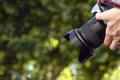 Photographer taking pictures of nature. Professional photo camera in hands of photographer. Photography concept Royalty Free Stock Photo