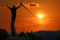 Photographer taking pictures outdoors, silhouette of a man with camera over sunset Royalty Free Stock Photo