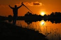 Photographer taking pictures outdoors, silhouette of a man with camera over sunset Royalty Free Stock Photo