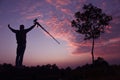 Photographer taking pictures outdoors, silhouette of a man with camera over sunset Royalty Free Stock Photo