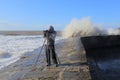 Photographer taking pictures of waves