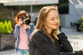 Photographer taking pictures of woman outdoor