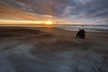 Photographer taking a sun set photograph on hokitika beach south Royalty Free Stock Photo