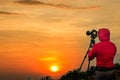 Photographer taking Thailand travel twilight sky photography. Woman photographer shooting with tripod and DSLR camera at sunset  w Royalty Free Stock Photo