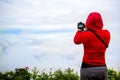 Photographer taking travel nature photography. Woman photographer shooting with tripod and dslr camera in sunset with beautiful l Royalty Free Stock Photo