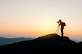 Photographer on top of mountain at sunset background Royalty Free Stock Photo