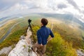 Photographer on top of the mountain takes on the camera Royalty Free Stock Photo