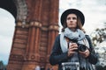 Photographer tourist with photo camera. Portait girl in hat travels in Triumphal arch Barcelona. Holiday concept in europe Royalty Free Stock Photo