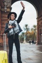 Photographer tourist with retro photo camera. Girl in hat travels in Triumphal arch Barcelona. Holiday concept in europe street Royalty Free Stock Photo