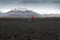 Photographer tourist stands in the mountains and from a tripod t Royalty Free Stock Photo