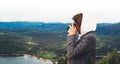 Photographer tourist traveler standing on green top on mountain holding in hands digital photo camera, hiker taking click photogra Royalty Free Stock Photo