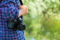 Photographer or traveler concept. Photographer holding digital camera in his hands with copy space Royalty Free Stock Photo