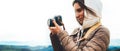 Photographer traveler on green top on mountain, tourist looking enjoy nature panoramic landscape in trip, girl holding in hands di Royalty Free Stock Photo