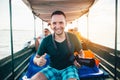 Photographer travelling by boat and watching the birds of the Danube Delta at sunset Royalty Free Stock Photo