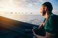 Photographer travelling by boat and watching the birds of the Danube Delta at sunset Royalty Free Stock Photo